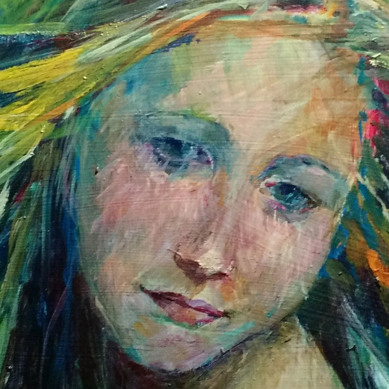 Close-up of expressive abstract portrait painting of a woman's face with vibrant brushstrokes